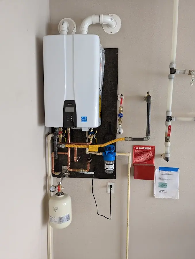 Professional plumber installing copper piping in a Terre Haute home